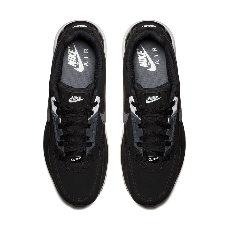 Pair of black low-top sneakers with black laces and AIR MAX size labels on tongue