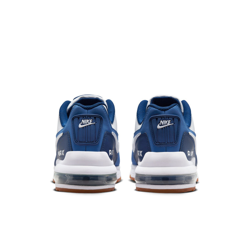 Men's sneakers rear view with blue heel panels, cushioned back, and air unit