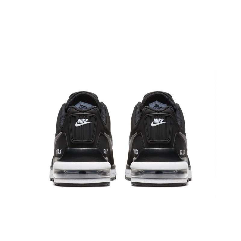 Pair of black low-top sneakers with cushioned heels and AIR branding on heel tabs