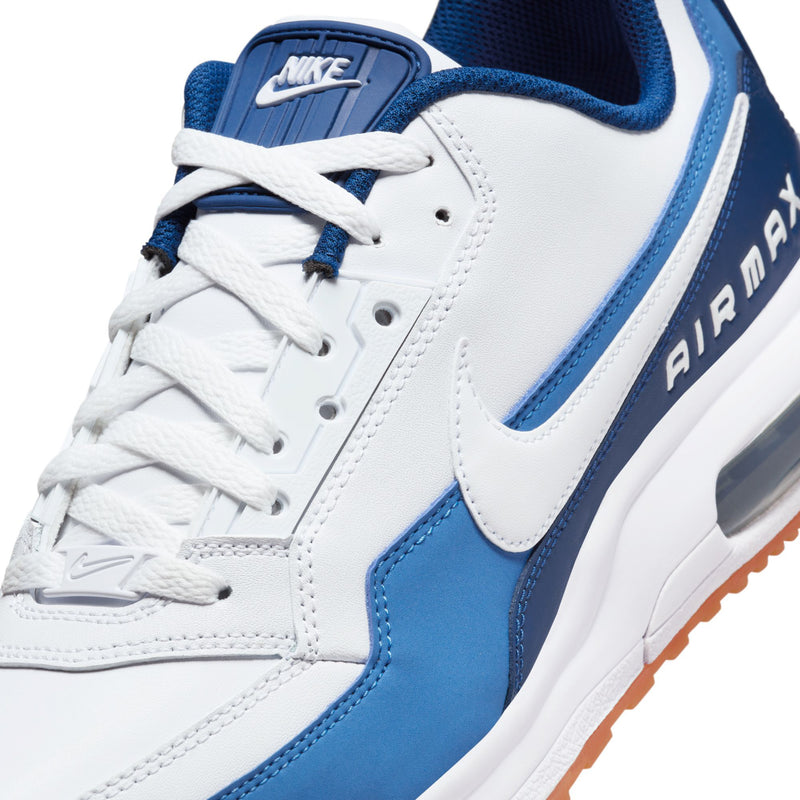 Close-up of men's white sneakers with blue swoosh, lace-up detailing, and AIR MAX branding