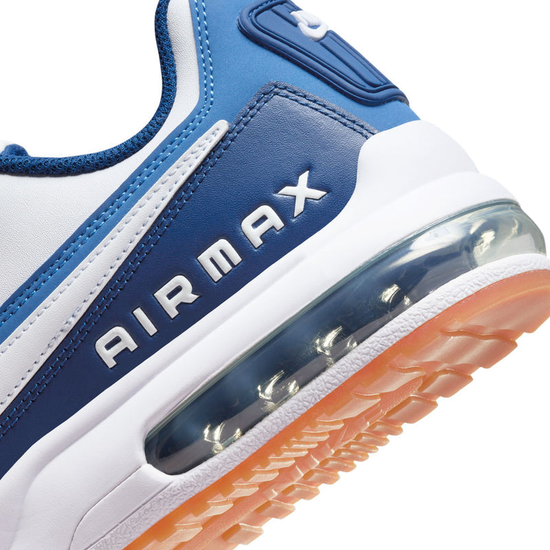 Close-up side view of men's sneakers with blue upper, AIR MAX text, and Air window