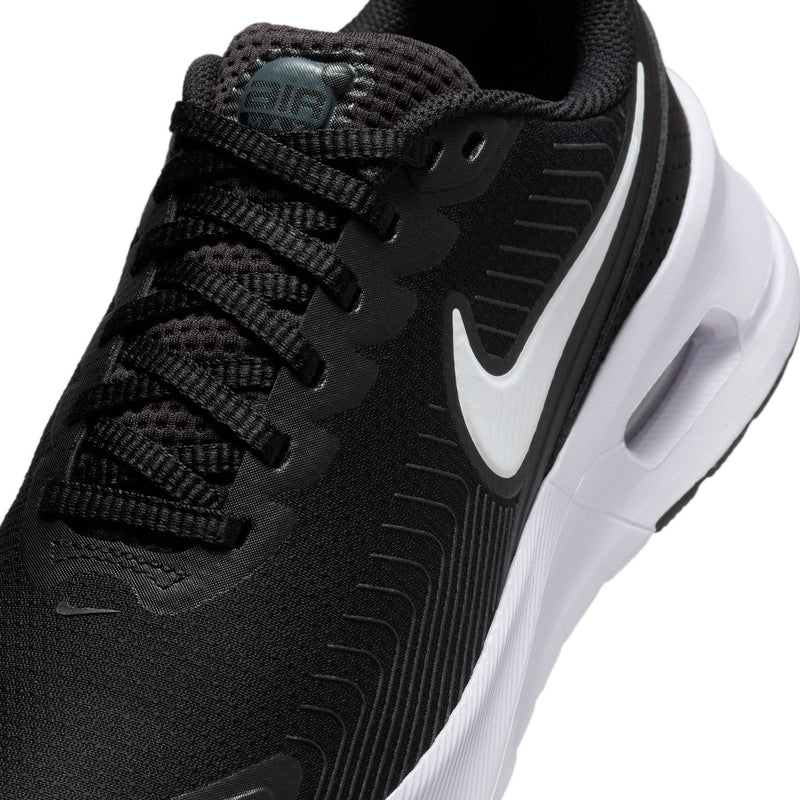 Close-up of black Nike women's sneaker upper with laces and swoosh