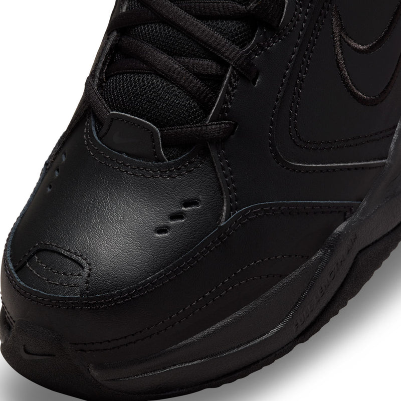 Men's black sneaker toe area with textured leather and stitched panel