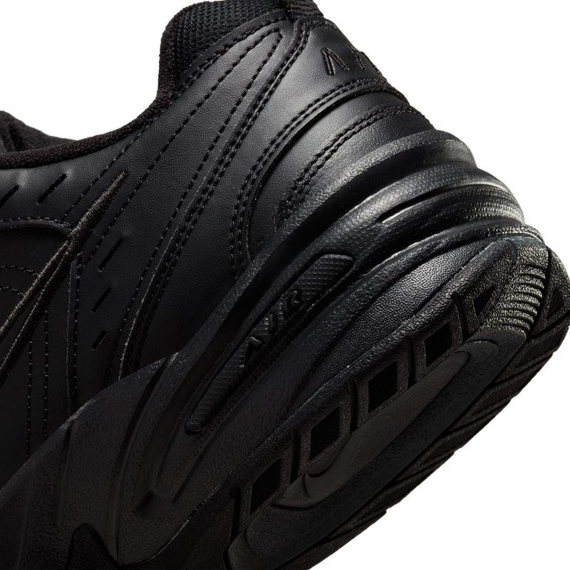 Men's black sneaker midsole close-up with ridged cushioning detail
