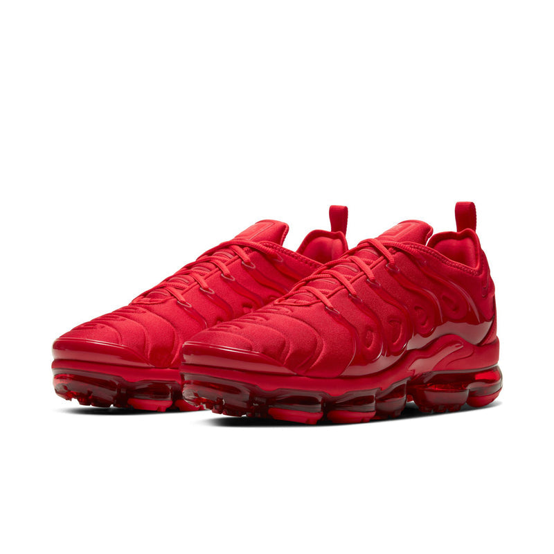 Men's red lace-up running shoe with wavy overlays and visible Air unit in the sole.