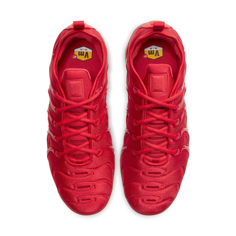Pair of men's red sneakers viewed from above, laced uppers and cushioned collars.