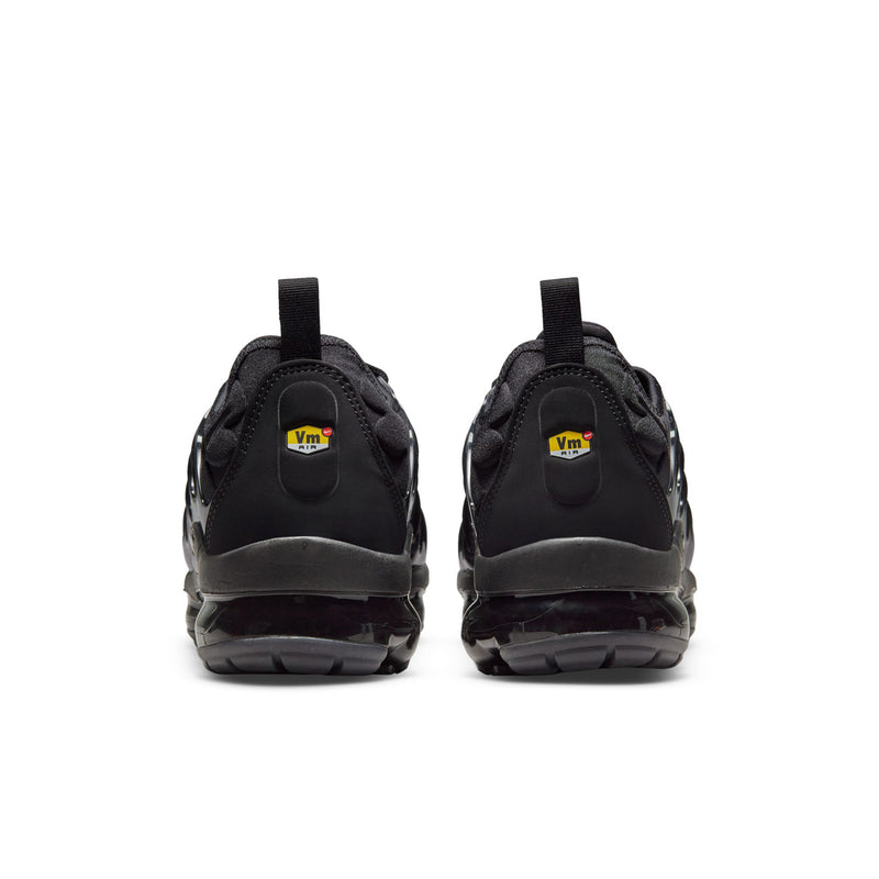 Men's black sneakers, rear view with heel tab and molded sole