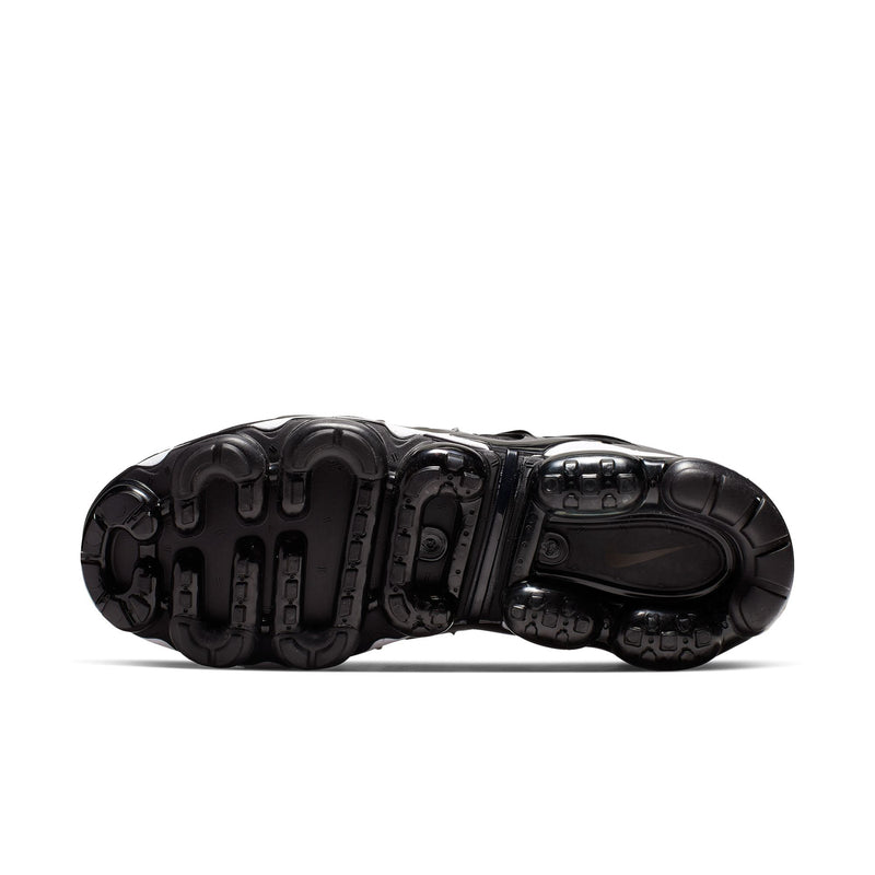 Underside view of men's black running shoes with textured tread outsole