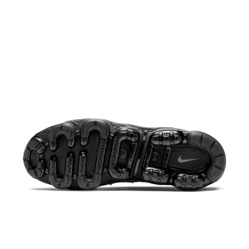 Air-cushion sneaker outsole with tread pattern, black pods, and Nike logo