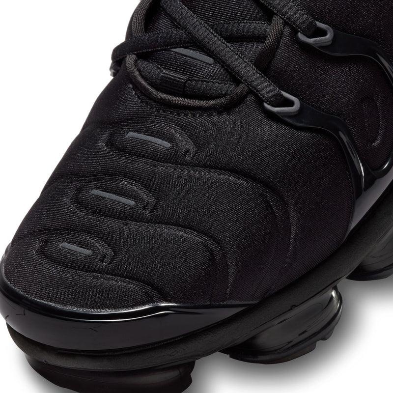 Men's black knit upper sneaker with textured swoosh detail