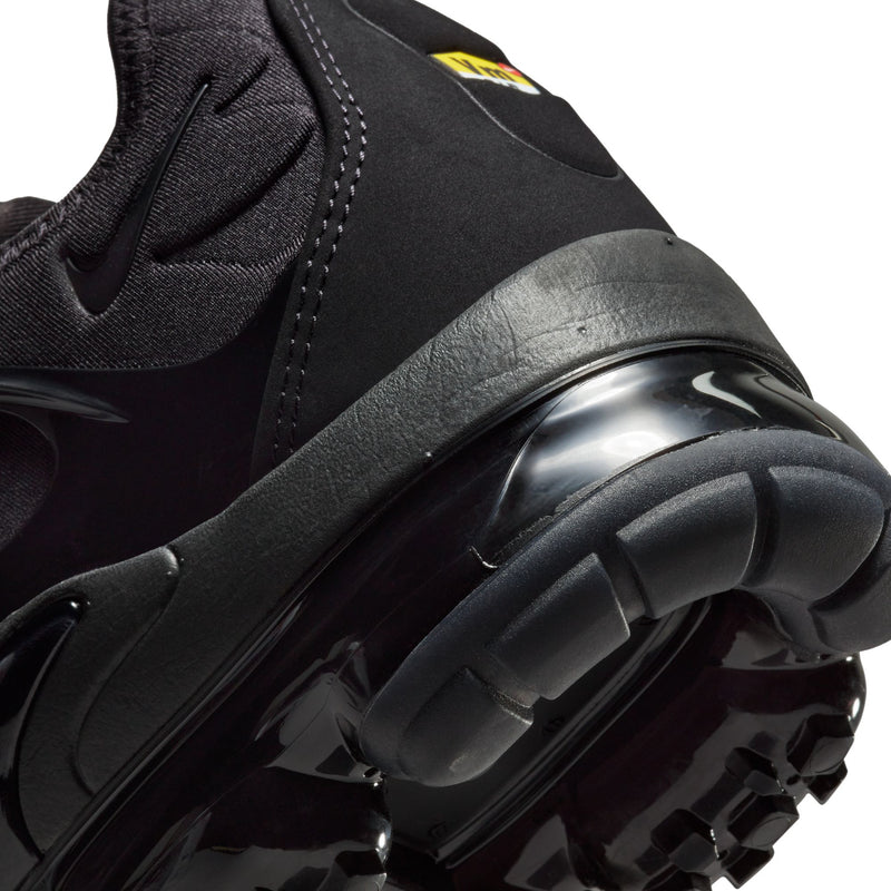 Men's black sneaker close-up of Air pod outsole and side overlay
