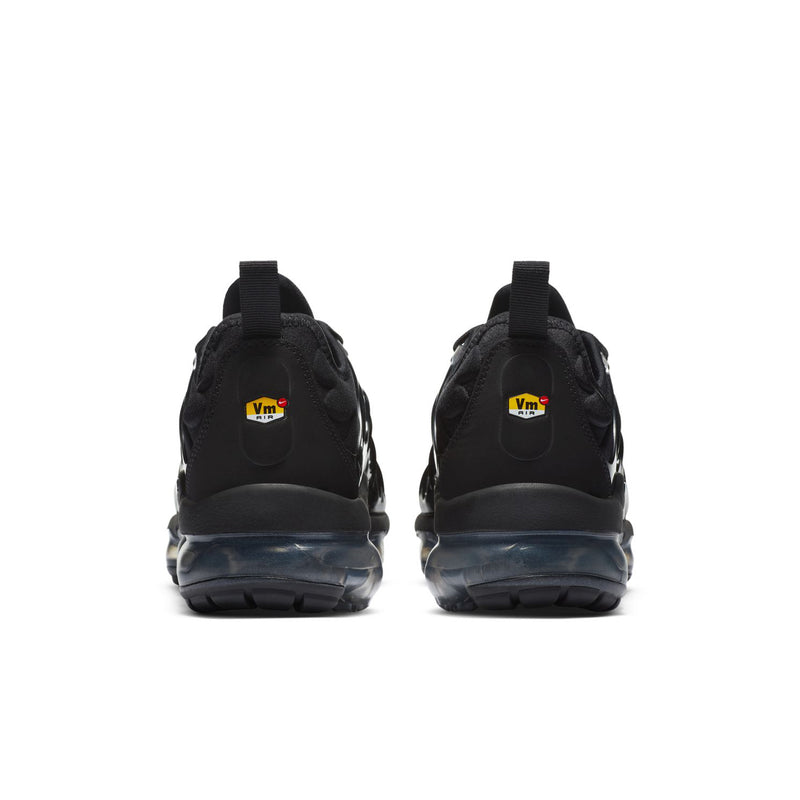 Women's black sneakers from heel view with cushioned back tab and air-sole cushioning.