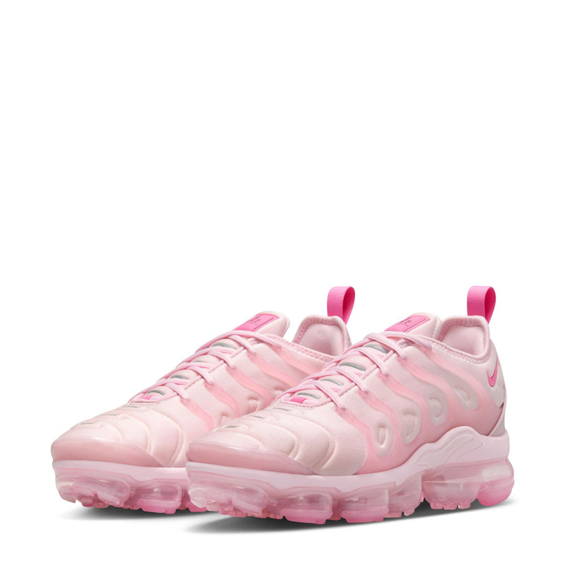 Women’s pink Nike lace-up sneakers, side view with durable rubber tread