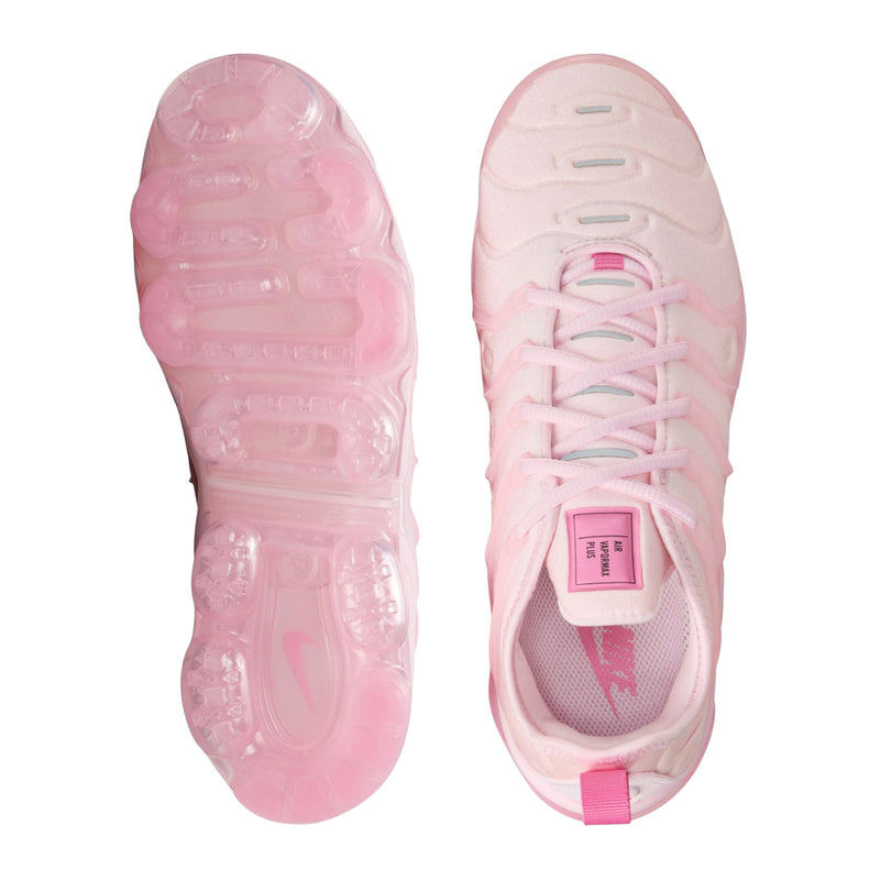 Women’s pink Nike sneakers, sole and tongue view with lace-up and logo label