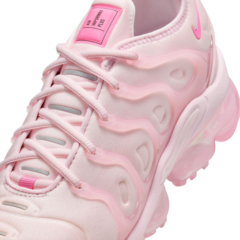 Women’s pink Nike sneakers close-up of lace-up top and padded collar