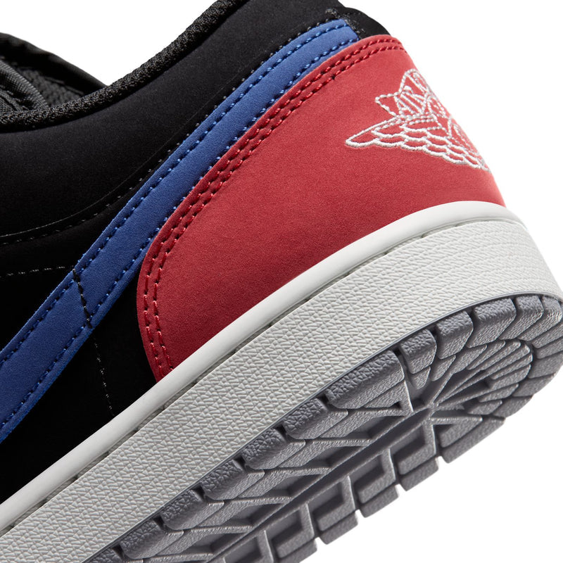 Close-up of black and red sneaker heel with blue stripe and white outsole tread