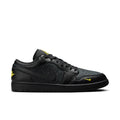 Men's black low-top sneakers with yellow accents and stitched swoosh logo