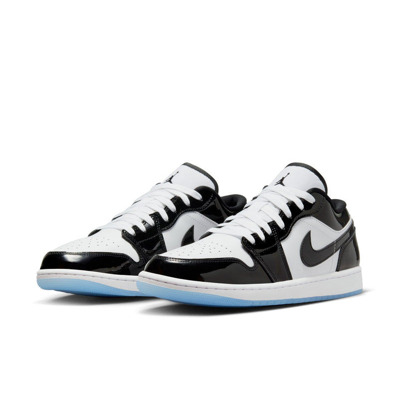 Mens low-top sneakers, white and black, front 3/4 view with Nike swoosh and blue sole