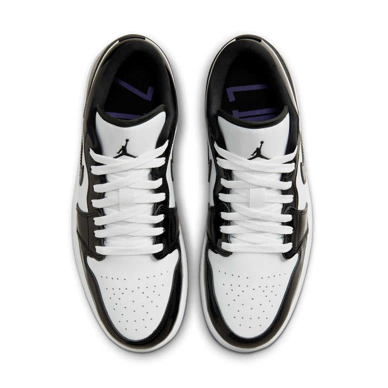 Mens low-top sneakers showing tongues and laces, white uppers with black overlays