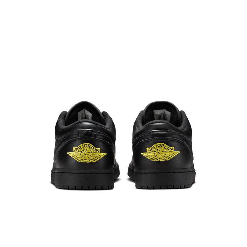 Black low-top sneakers, rear view with Air Jordan wing logo in yellow