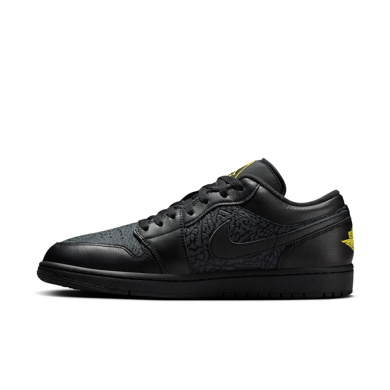 Men's black low-top sneakers with embossed pattern and yellow side accent