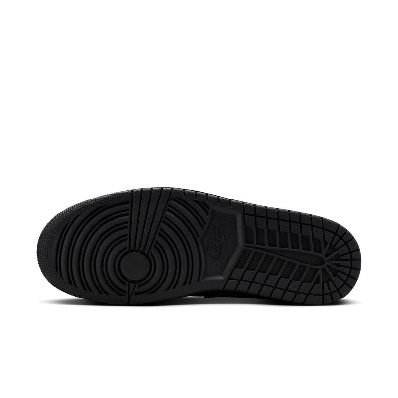 Black rubber outsole of low-top sneakers with textured circular traction pattern