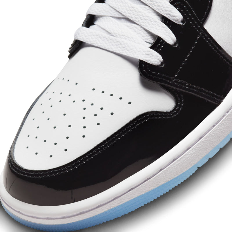 Mens sneaker toe and lace area, white leather with black overlays and perforations