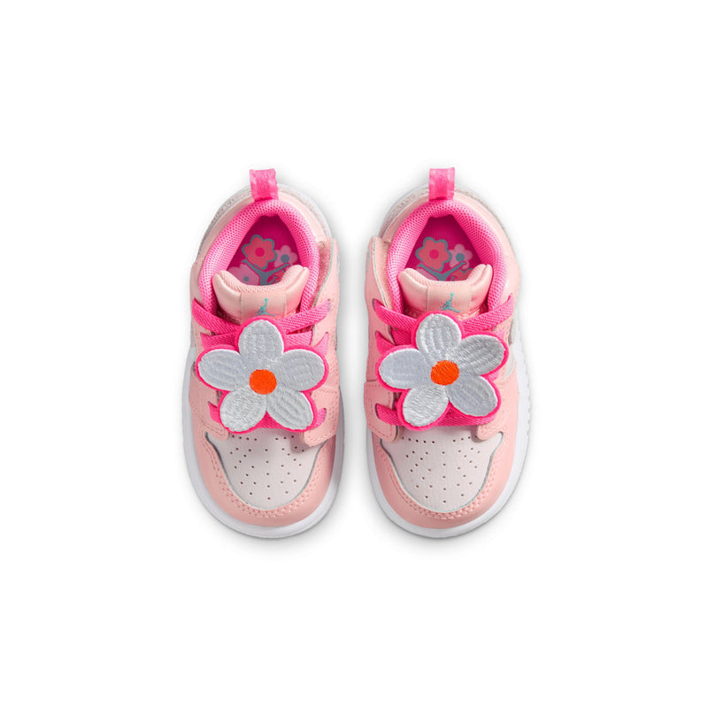 Pair of pink toddler sneakers with flower graphics on the inside and hook-and-loop straps