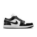 Black and white low-top sneakers with Nike swoosh and lace-up front