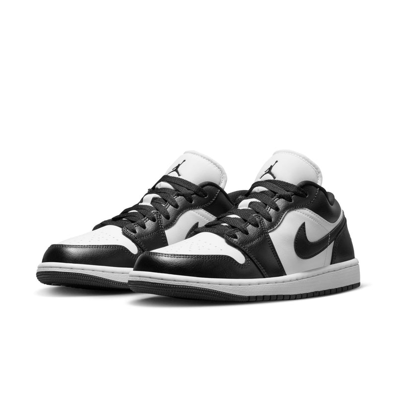 Pair of black and white low-top sneakers with Nike swoosh and lace-up design
