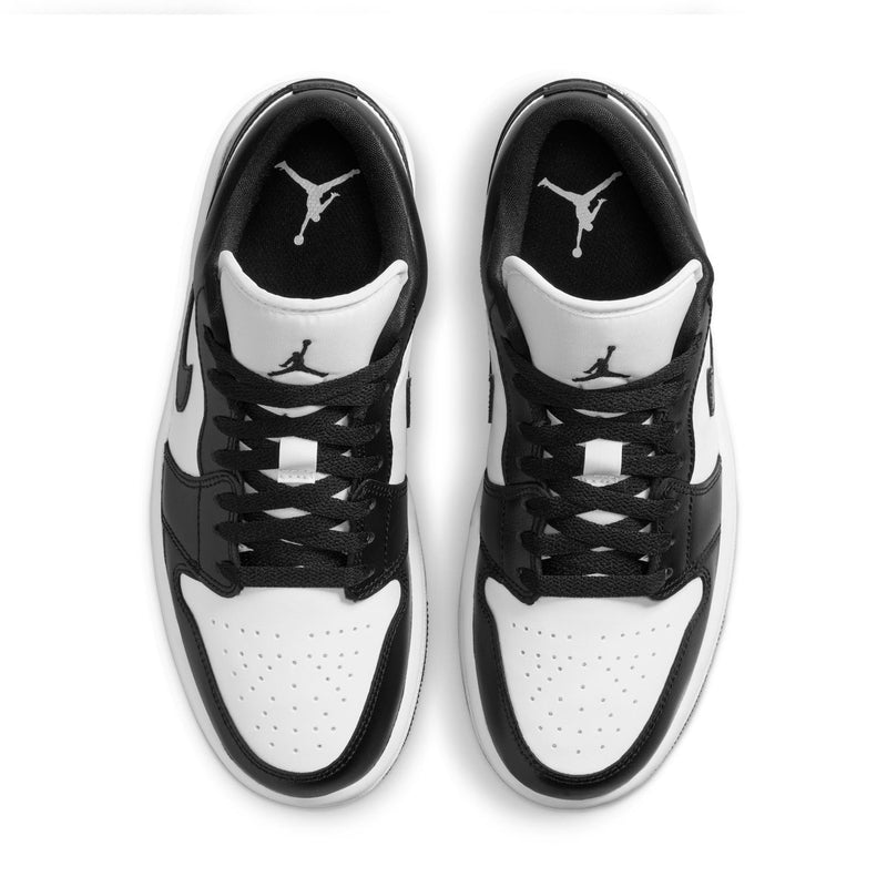 Black and white sneakers with lace-up front, perforated toe, and tongue logos