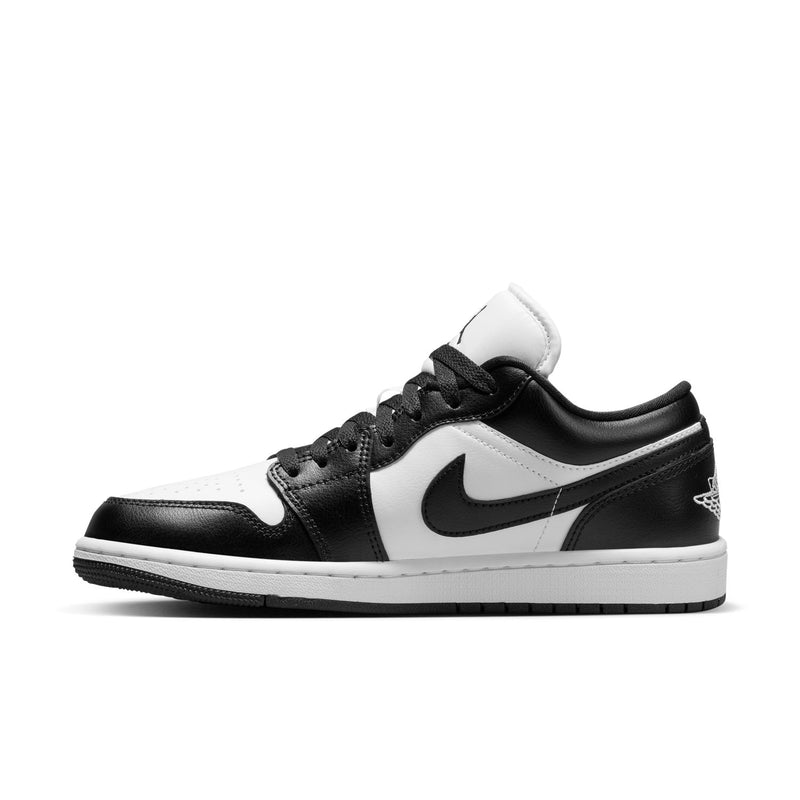 Black and white low-top sneakers side view with Nike swoosh and lace-up closure