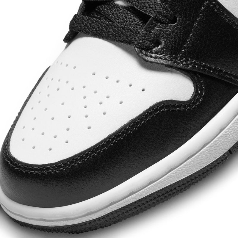 Black and white sneaker toe with perforations and stitched leather panel