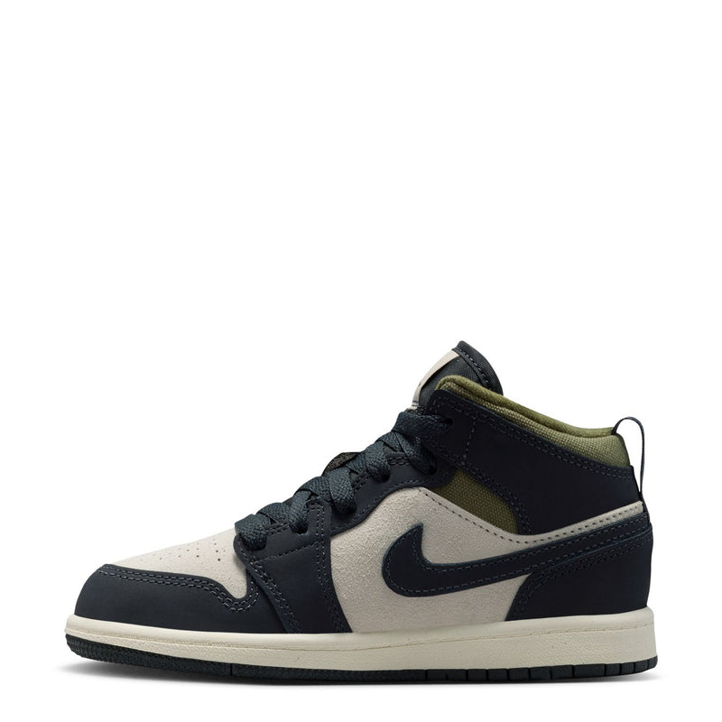 Kids' mid-top sneakers, side view, dark navy with light cream panels and olive lining