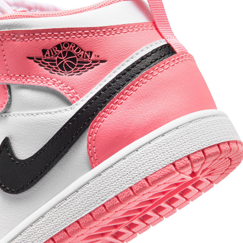Kids Air Jordan 1 Mid close-up: Air Jordan wing logo on pink, black swoosh, textured sole
