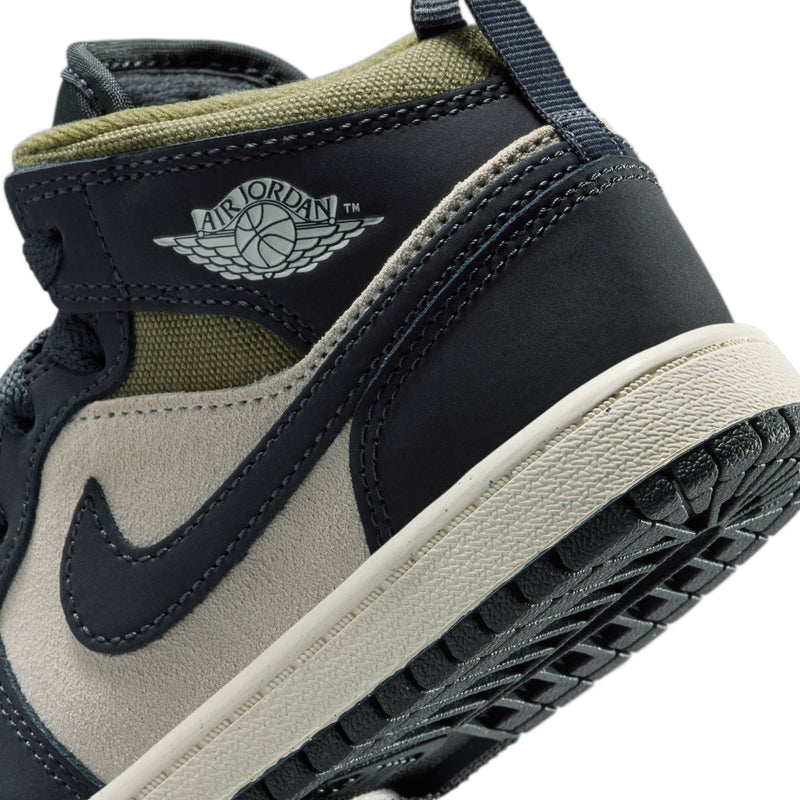 Kids' mid-top sneakers close-up of Air Jordan wing logo, navy and cream with olive collar