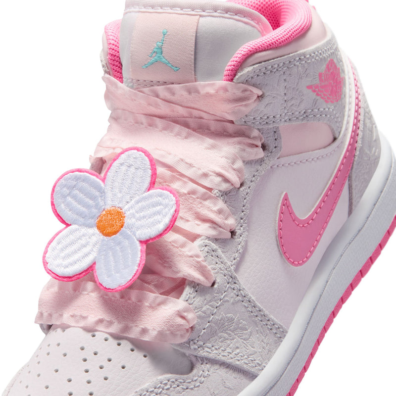 Kids mid-top sneakers close-up, light gray with pink lace bow and flower detail