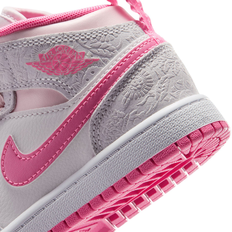 Kids mid-top sneakers detail, gray leather texture with pink Swoosh and outsole tread