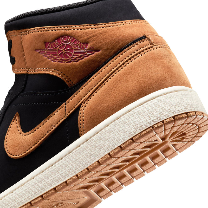 Close-up of tan heel area on black and wheat mid-top sneaker with Air branding