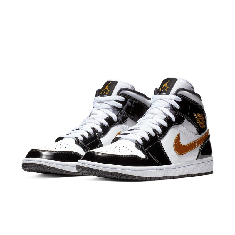 Pair of men's mid-top sneakers, black/white with metallic gold accents and swoosh