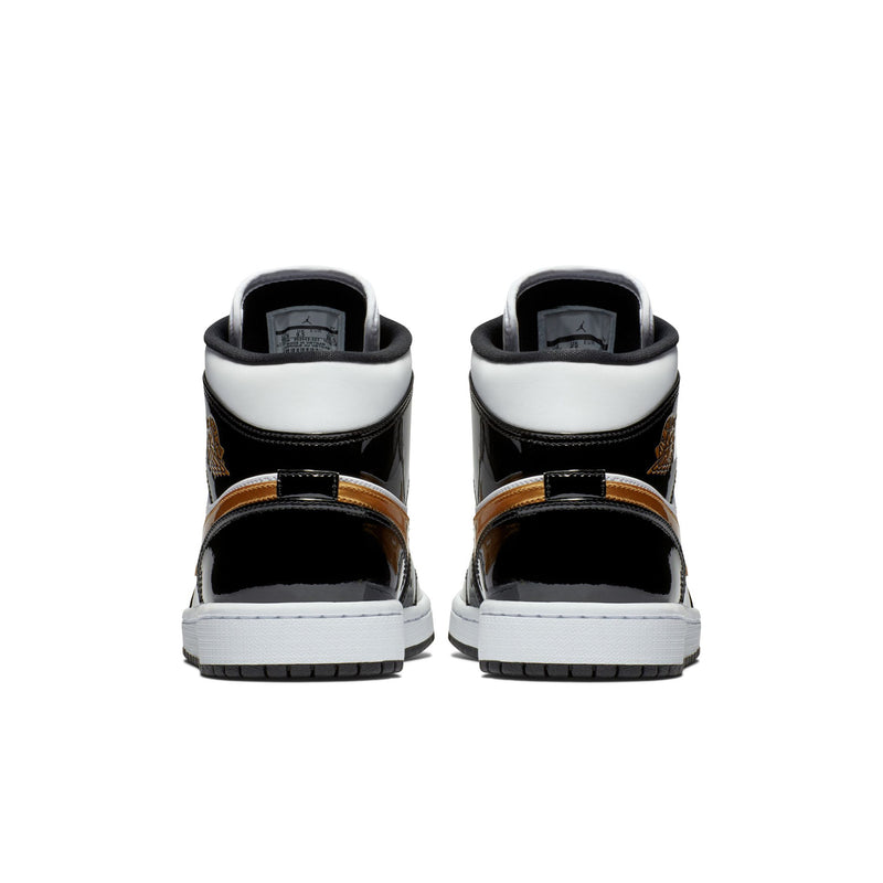 Men's mid-top sneakers, black and white with metallic gold strap details at heel