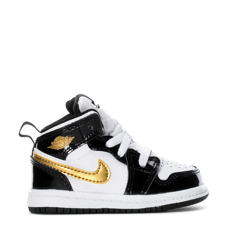 Toddler high-top sneakers, black and white with gold swoosh, lace-up side view