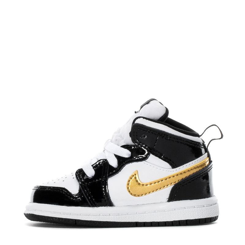 Toddler high-top sneakers, black and white with gold swoosh, angled side view