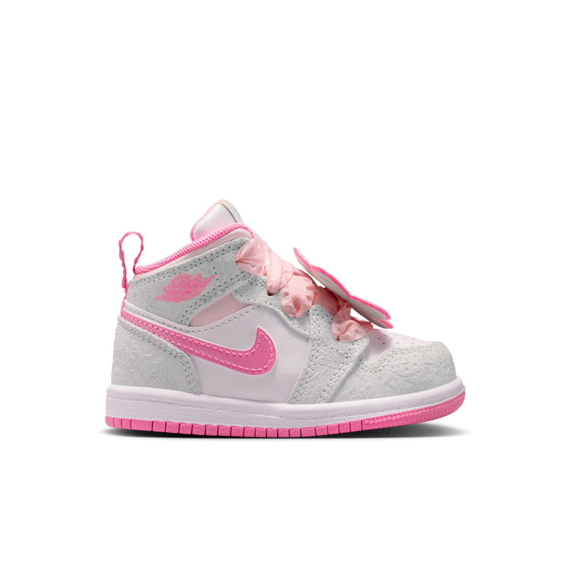 Toddler high-top sneakers in light gray with pink swoosh, pink laces, and ruffled tongue
