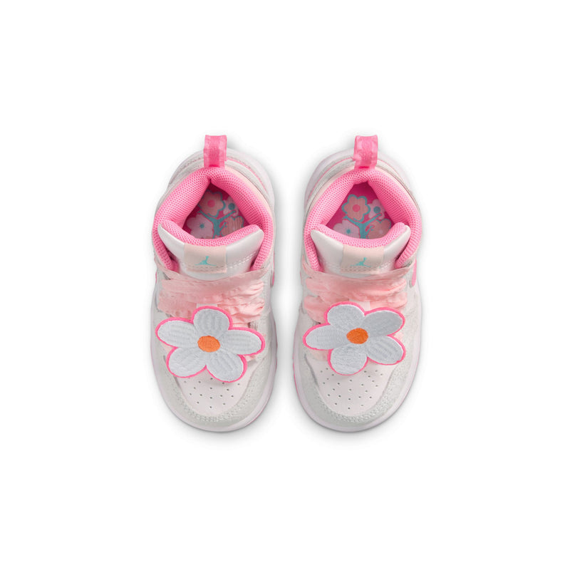 Toddler high-top sneakers showing pink heel pull tabs and flower graphics on the back