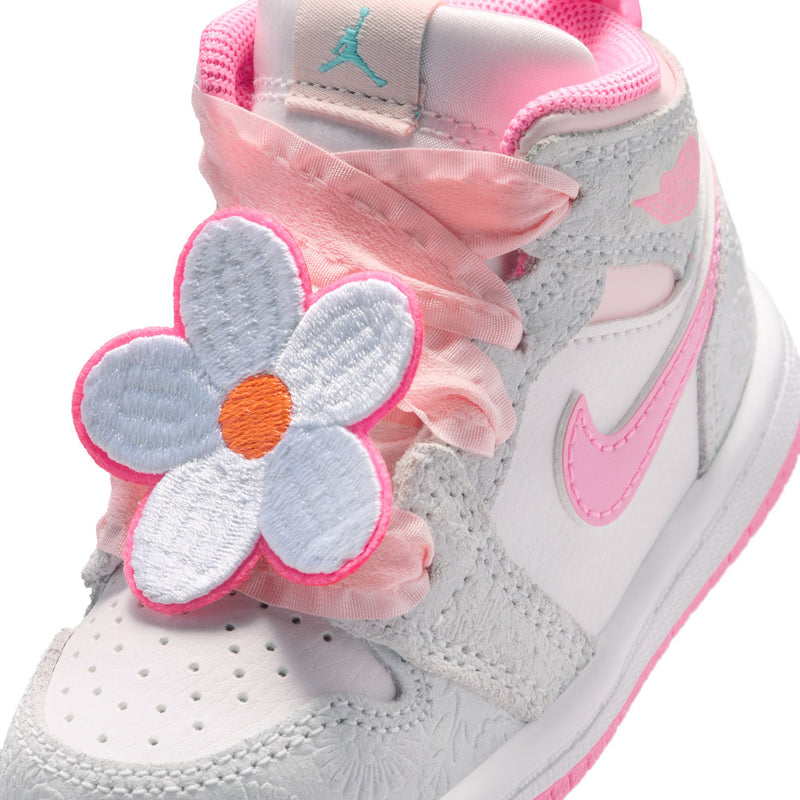 Toddler high-top sneaker close-up with gray fabric, pink flower applique, and pink lace bow