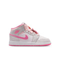 Youth mid-top sneakers angled side view in light gray with pink swoosh and laces.