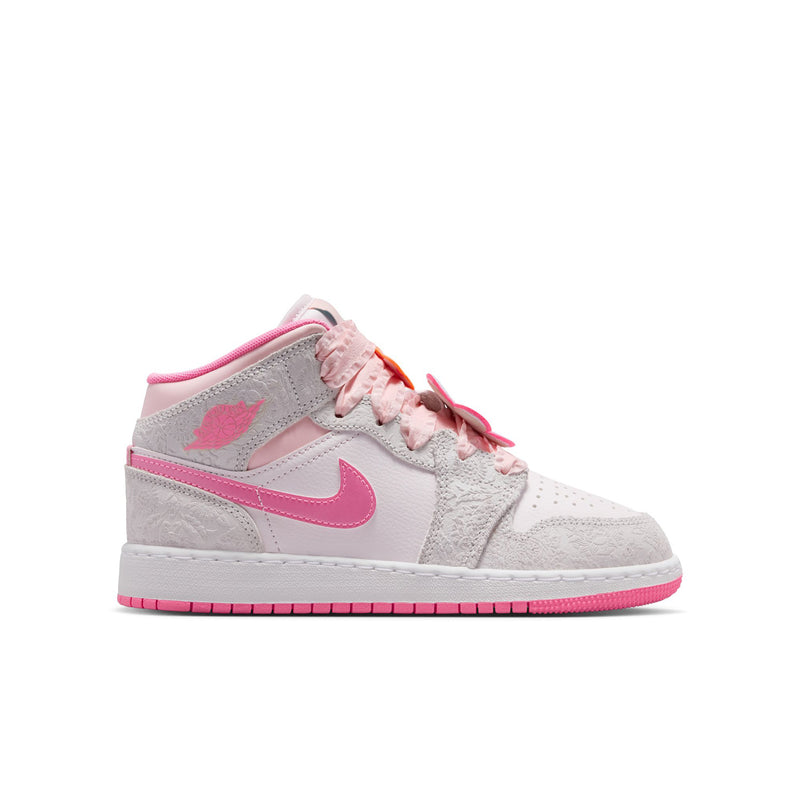Youth mid-top sneakers angled side view in light gray with pink swoosh and laces.