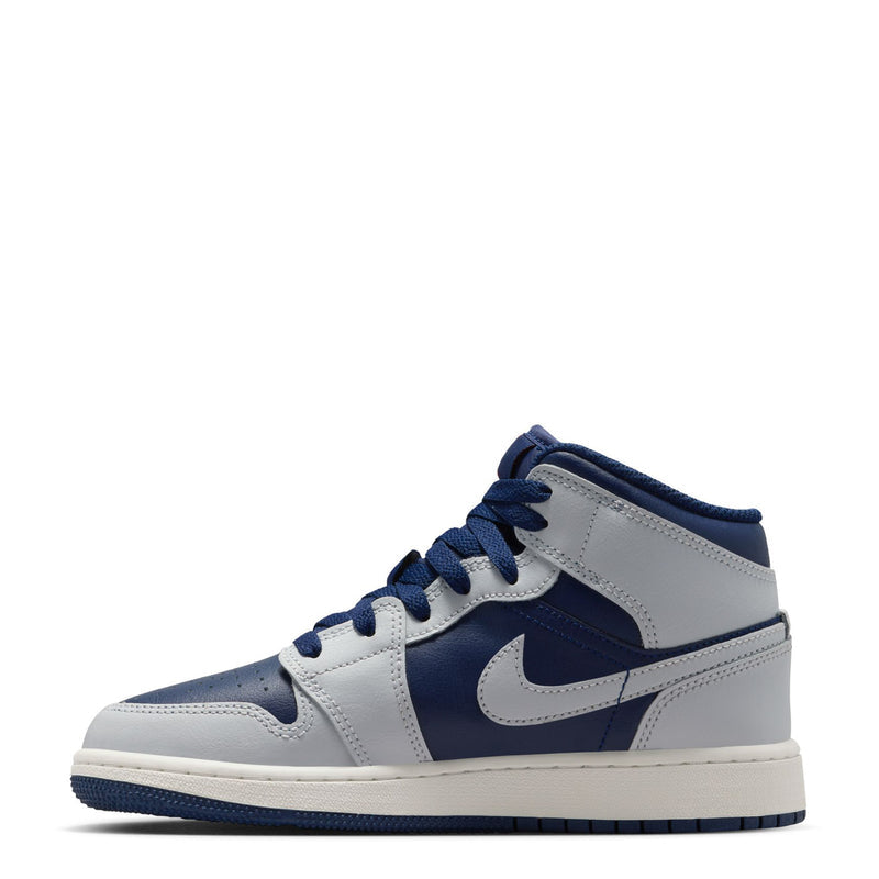 Youth mid-top sneakers with light gray panels and navy quarter, lace-up design