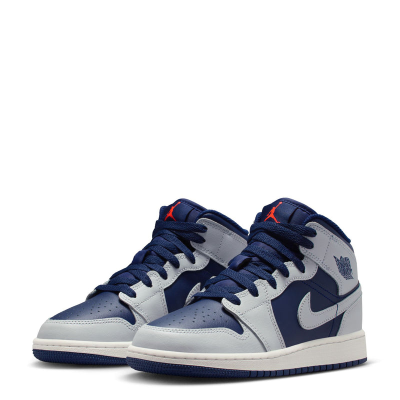 Pair of youth mid-top sneakers, navy and light gray colorway with white midsoles